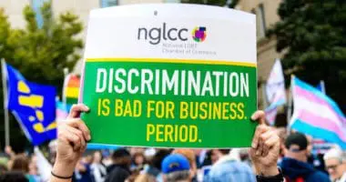 A protestor holds up a sign that reads 