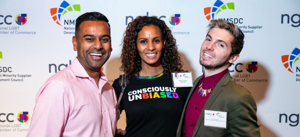 A group of three people smile at the camera at an NGLCC and NMSDC joint event.