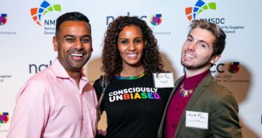 A group of three people smile at the camera at an NGLCC and NMSDC joint event.
